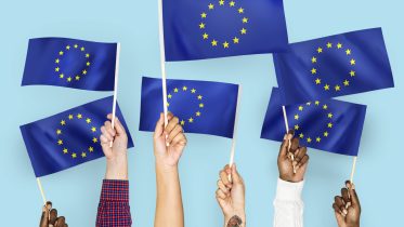 Hands waving flags of the EuropeanUnion